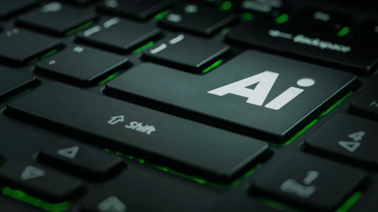 Tecla com a sigla AI em destaque no teclado preto de um notebook com luz verde