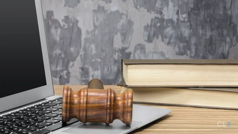 Notebook e martelo de juiz sobre a mesa de um escritório de advocacia